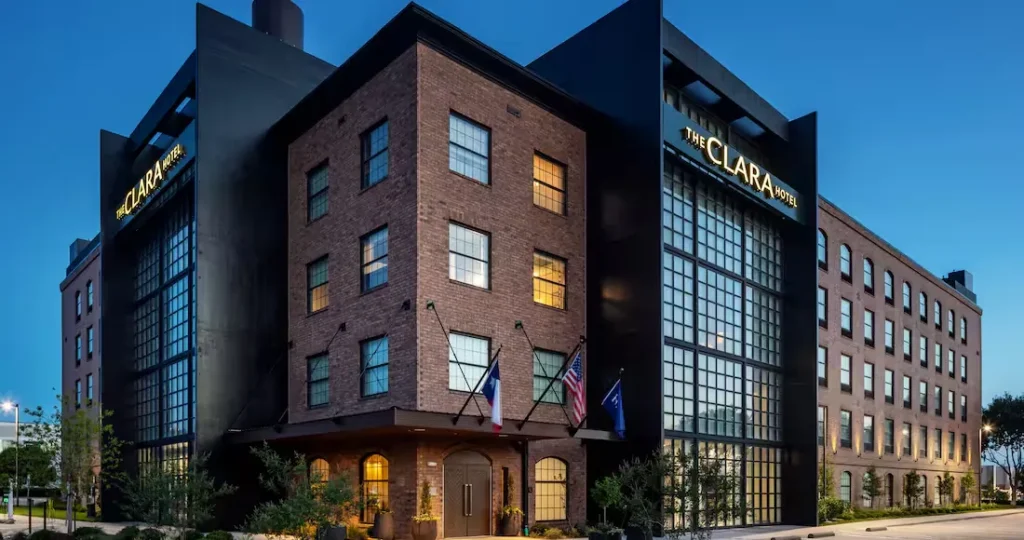 The Clara Hotel Plano Tapestry Collection by Hilton exterior at dusk